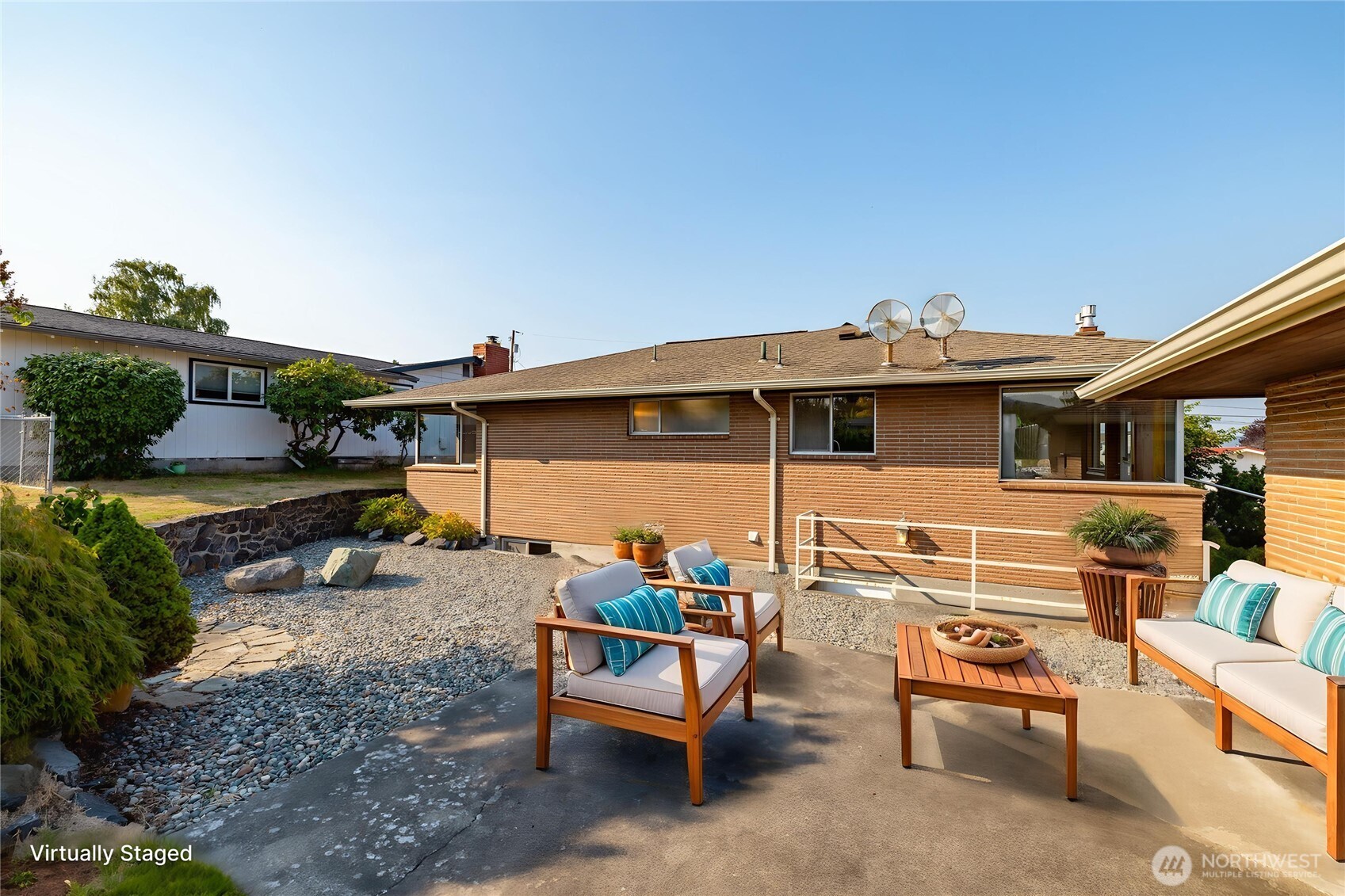 1307 26th Street Anacortes, WA 98221 - Photo 17 of 40 a view of a patio with table and chairs potted plants with wooden fence