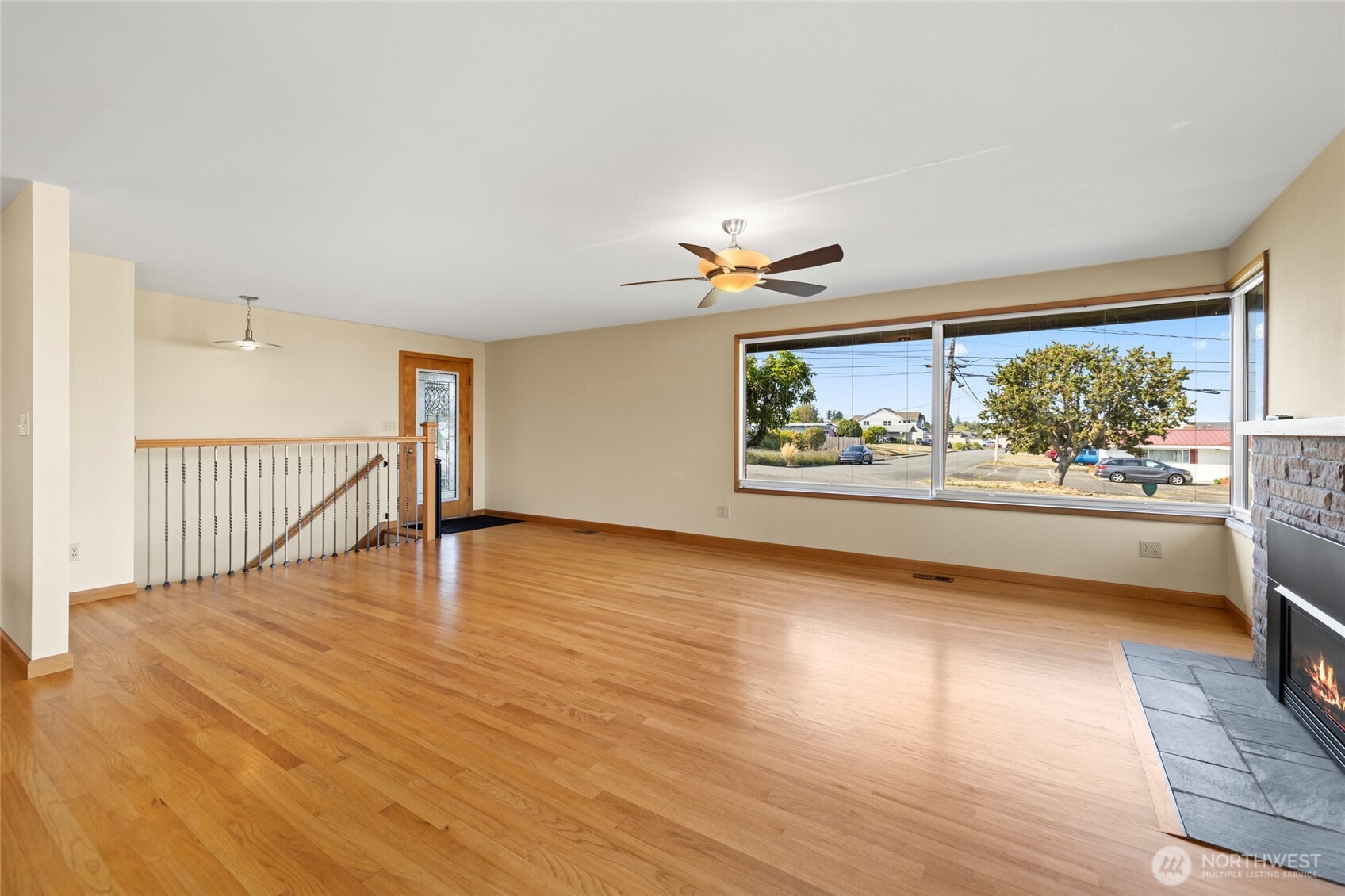 1307 26th Street Anacortes, WA 98221 - Photo 18 of 40 a view of an empty room with wooden floor and a window