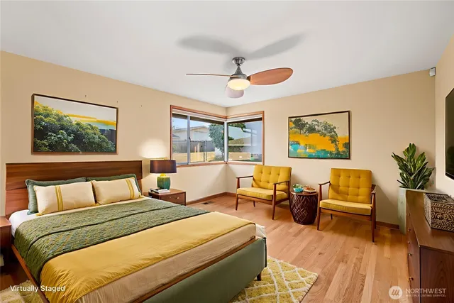 a bedroom with a bed and a painting on the wall