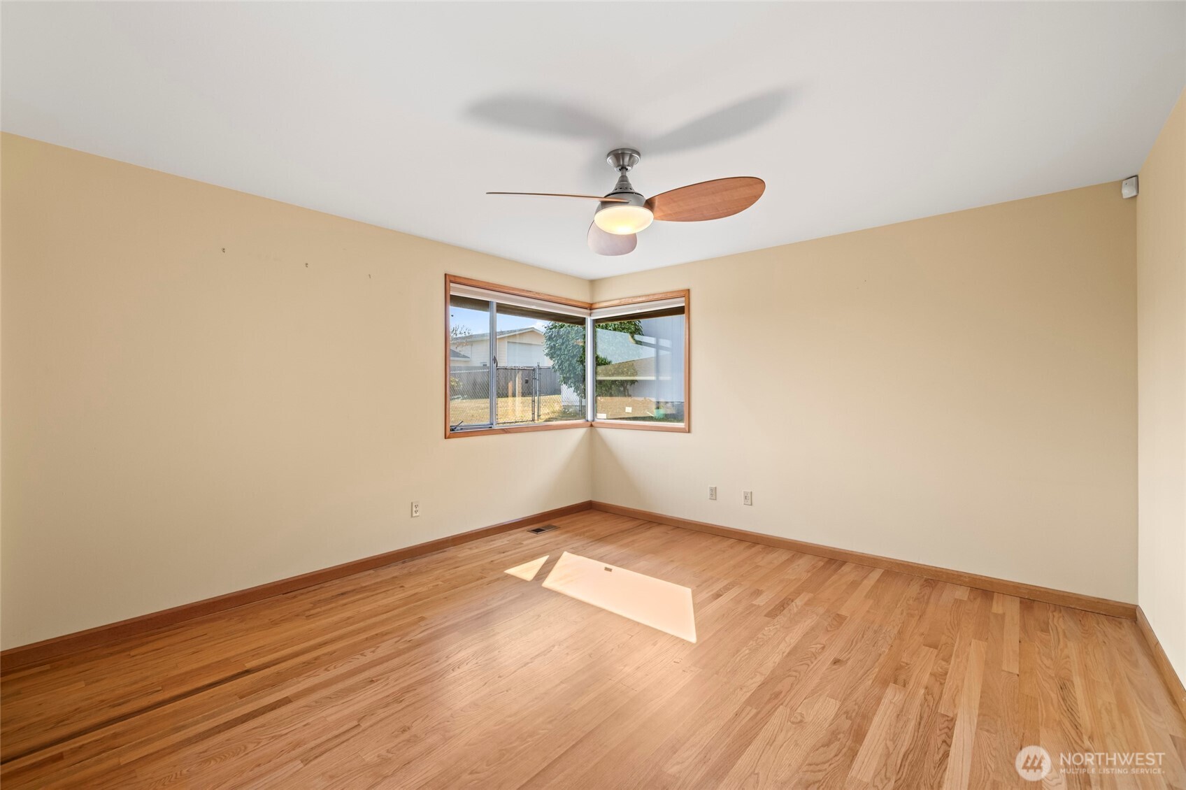 1307 26th Street Anacortes, WA 98221 - Photo 20 of 40 an empty room with wooden floor fan and windows