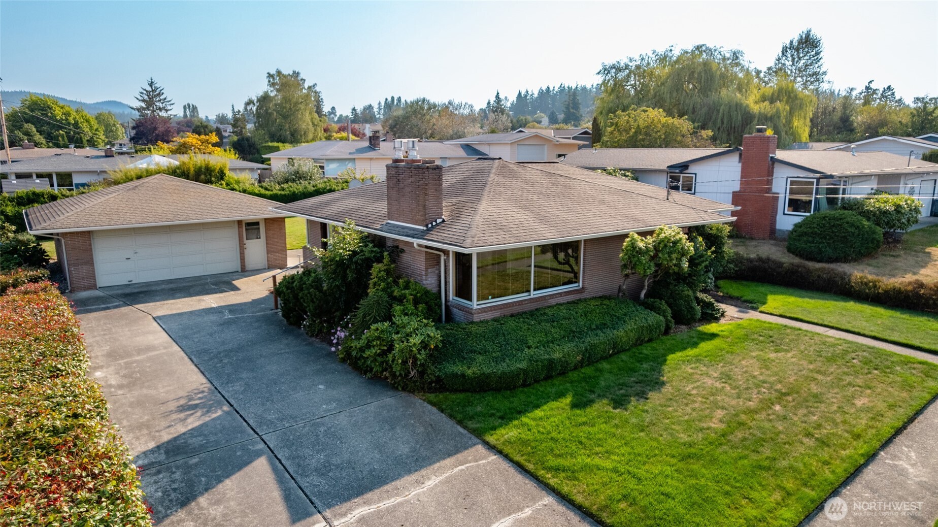 1307 26th Street Anacortes, WA 98221 - Photo 2 of 40 a aerial view of a house with a yard table and chairs