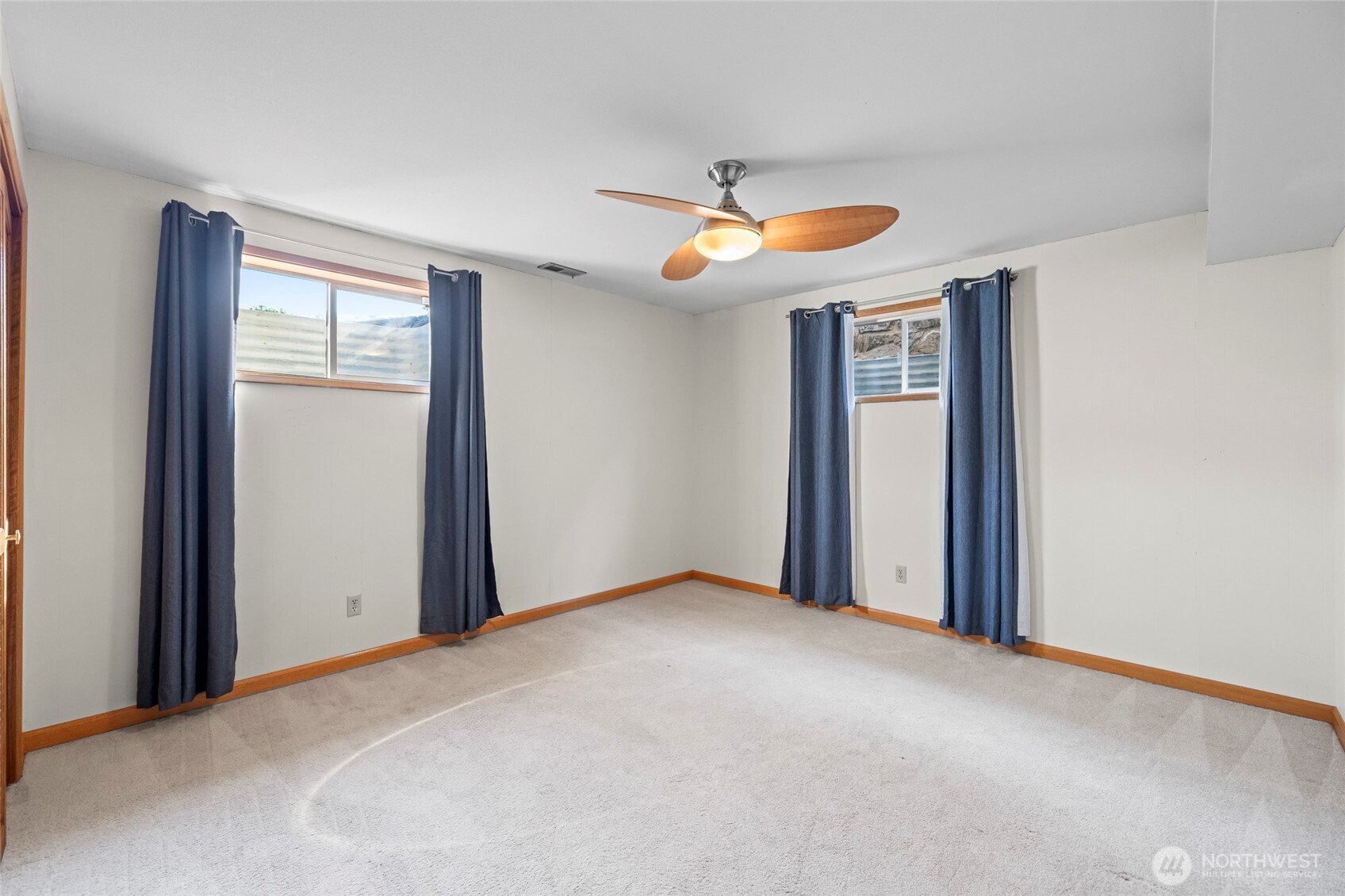 1307 26th Street Anacortes, WA 98221 - Photo 28 of 40 an empty room with windows and fan