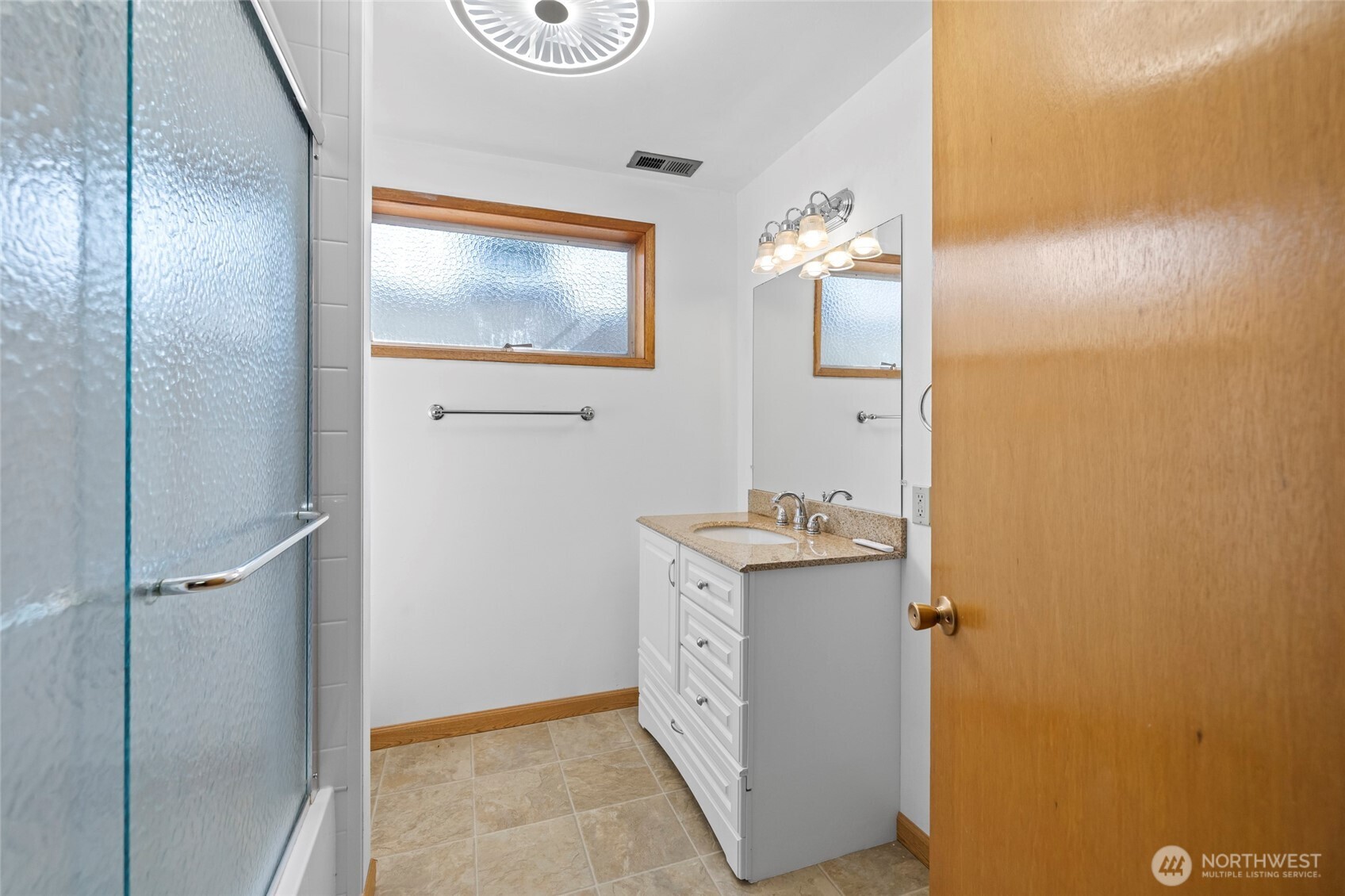 1307 26th Street Anacortes, WA 98221 - Photo 31 of 40 a bathroom with a granite countertop sink and a mirror