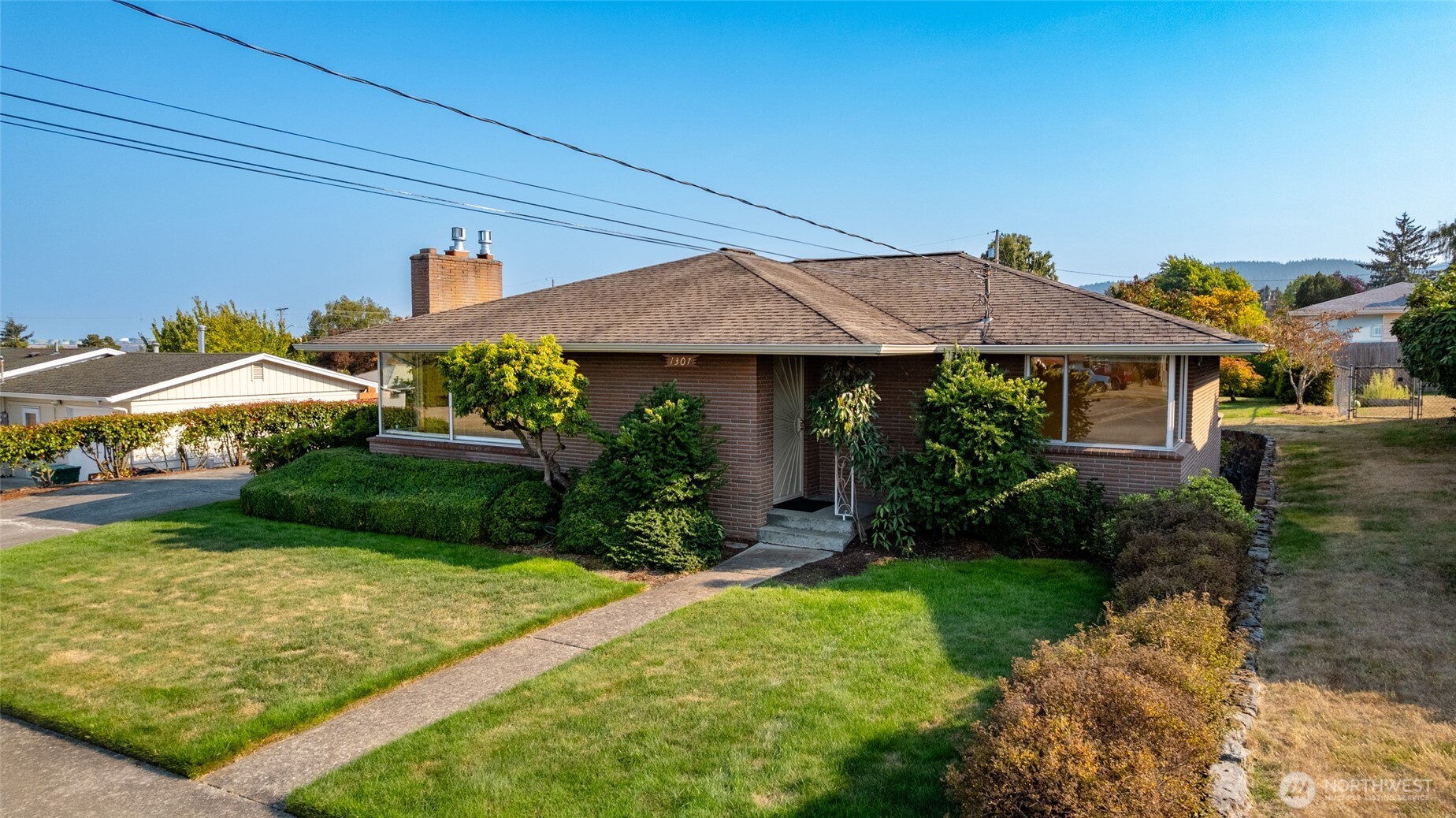 1307 26th Street Anacortes, WA 98221 - Photo 39 of 40 a view of house with garden and tall tress