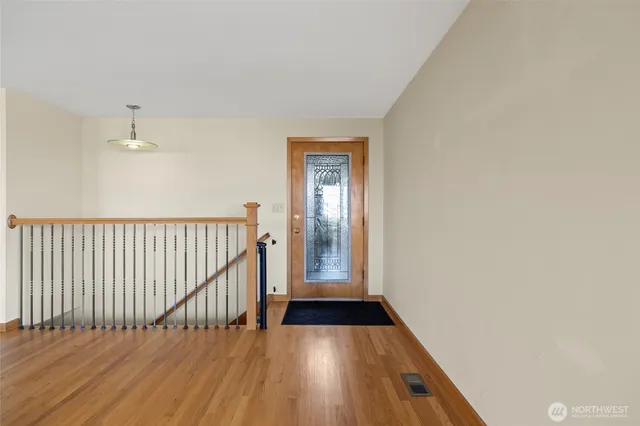 a view of an empty room with a fireplace and a window