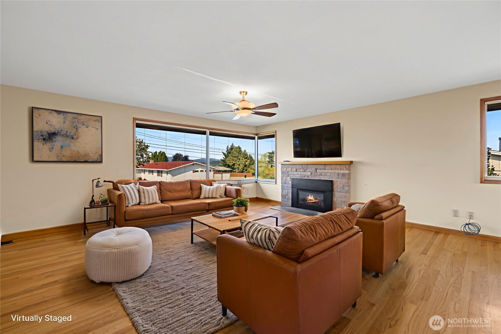 1307 26th Street Anacortes, WA 98221 - Photo 5 of 40 a living room with furniture a fireplace and a flat screen tv