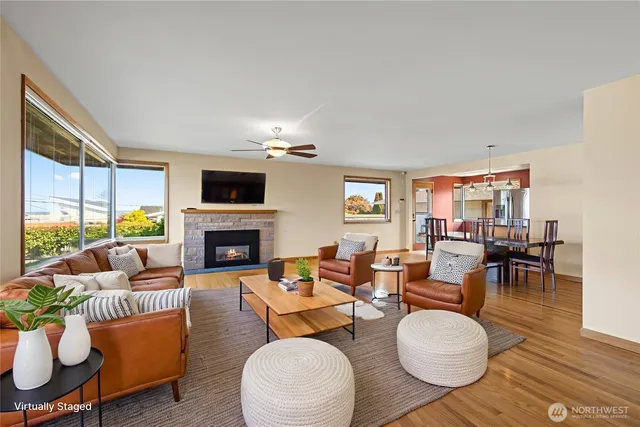 a view of a livingroom with furniture wooden floor and a ceiling fan