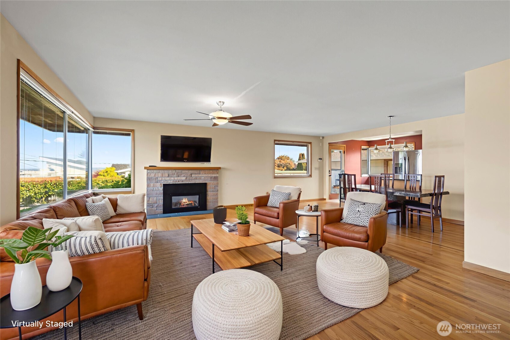 1307 26th Street Anacortes, WA 98221 - Photo 7 of 40 a living room with furniture a fireplace and a large window