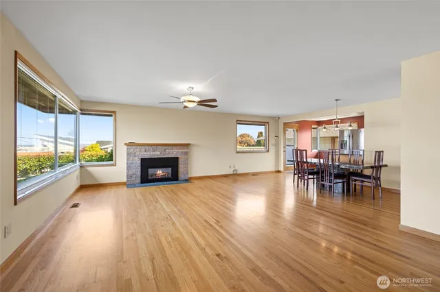 a view of a a dining room with furniture window and wooden floor