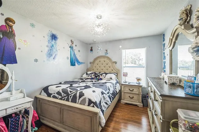 a bedroom with a bed and a chandelier