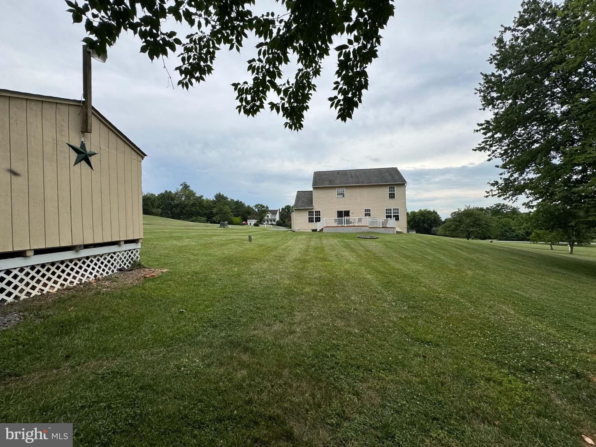 3826 Roundtree Road Jefferson, MD 21755 - Photo 3 of 19 a view of a white house with a big yard and large trees