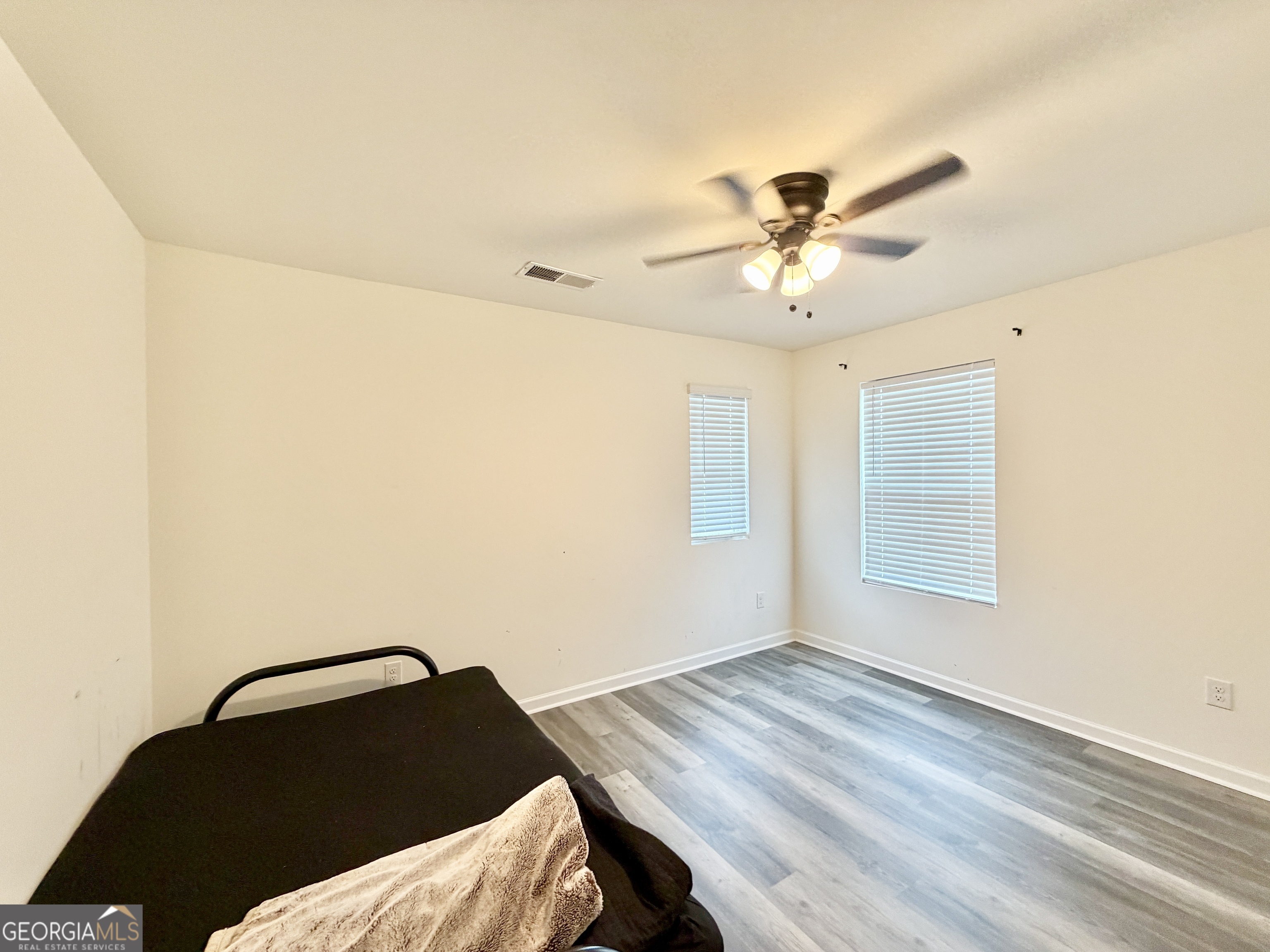 219 Barnyard Way Perry, GA 31069 - Photo 28 of 44 a bedroom with a bed and a ceiling fan