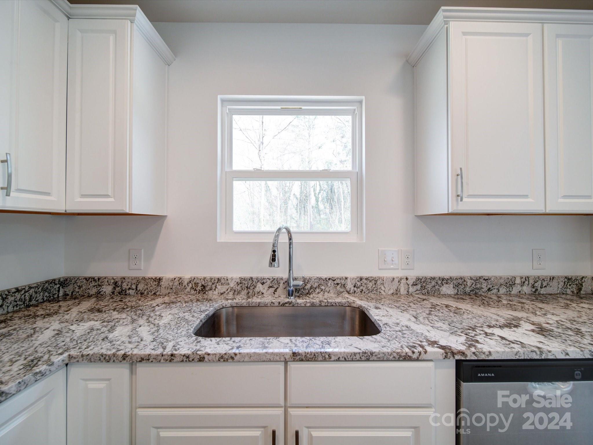 147 Lambeth Road Thomasville, NC 27360 - Photo 11 of 33 a kitchen with granite countertop white cabinets and a sink