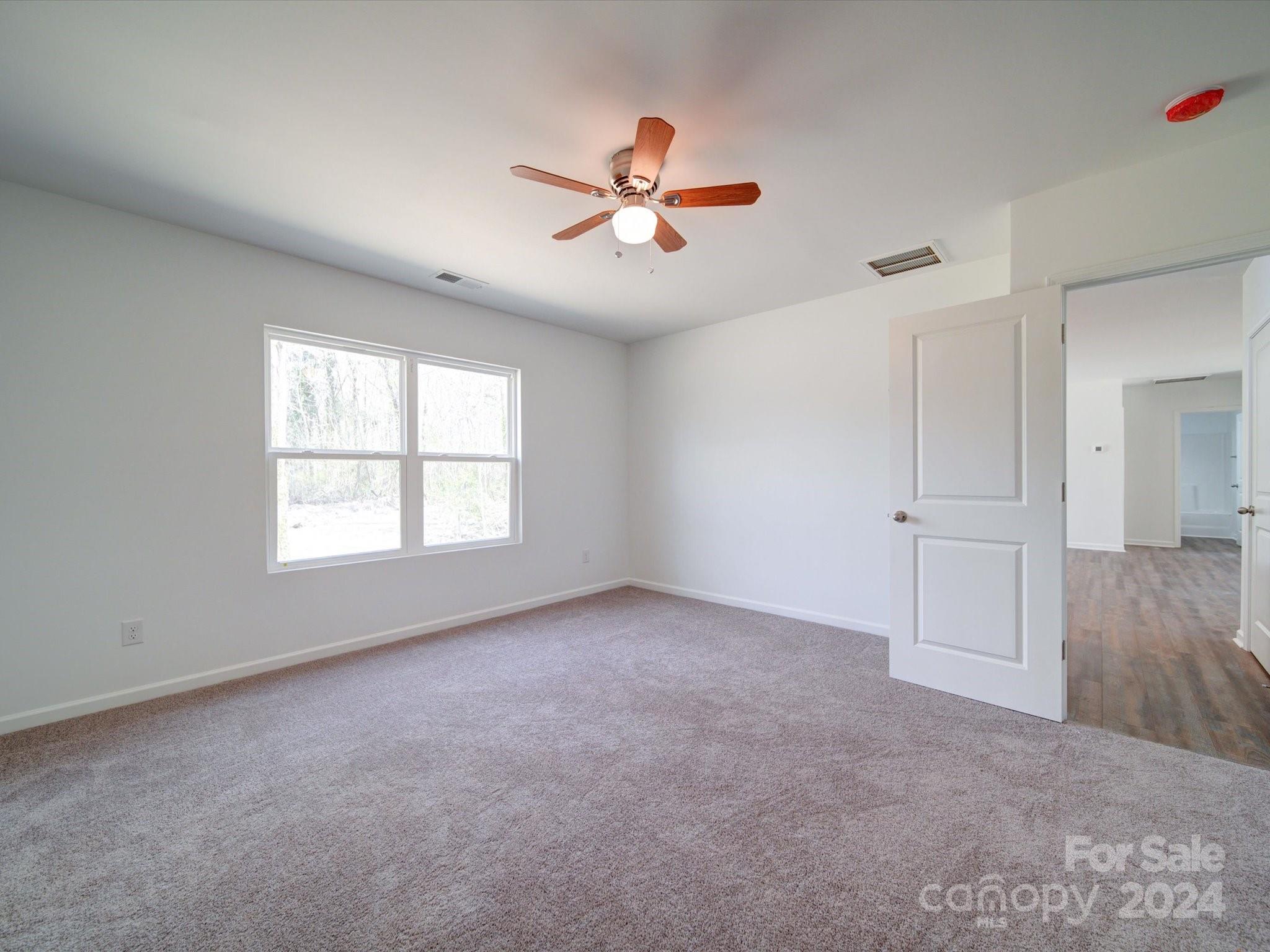 147 Lambeth Road Thomasville, NC 27360 - Photo 16 of 33 wooden floor in an empty room with a window