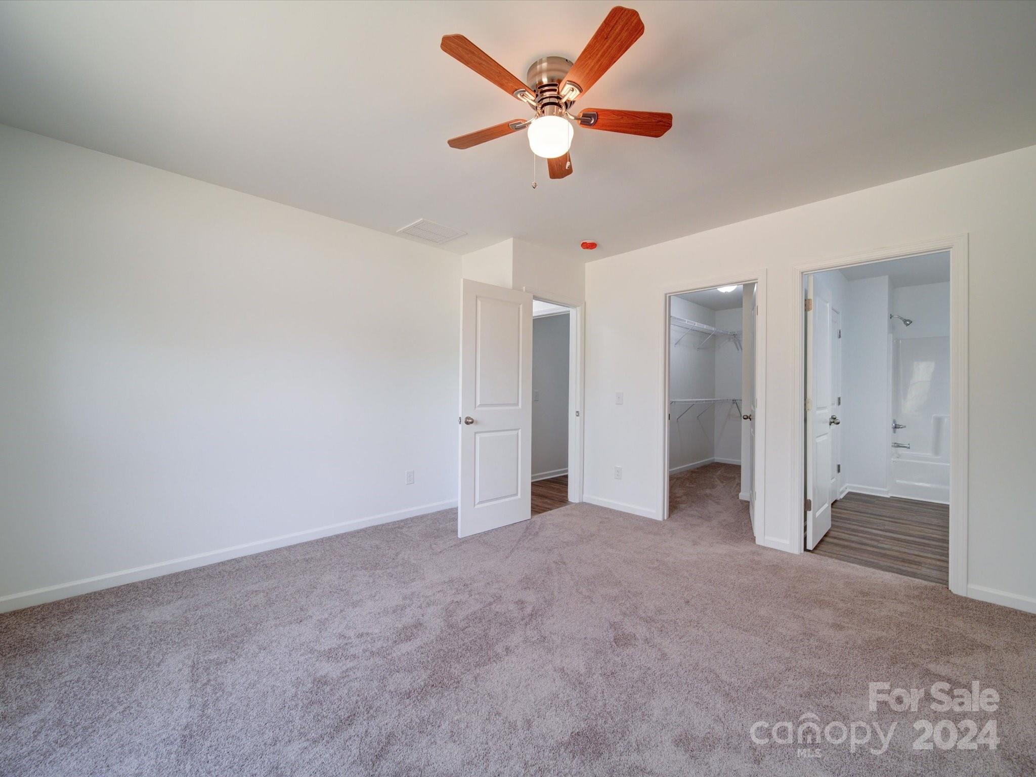 147 Lambeth Road Thomasville, NC 27360 - Photo 17 of 33 an empty room with closet and a ceiling fan