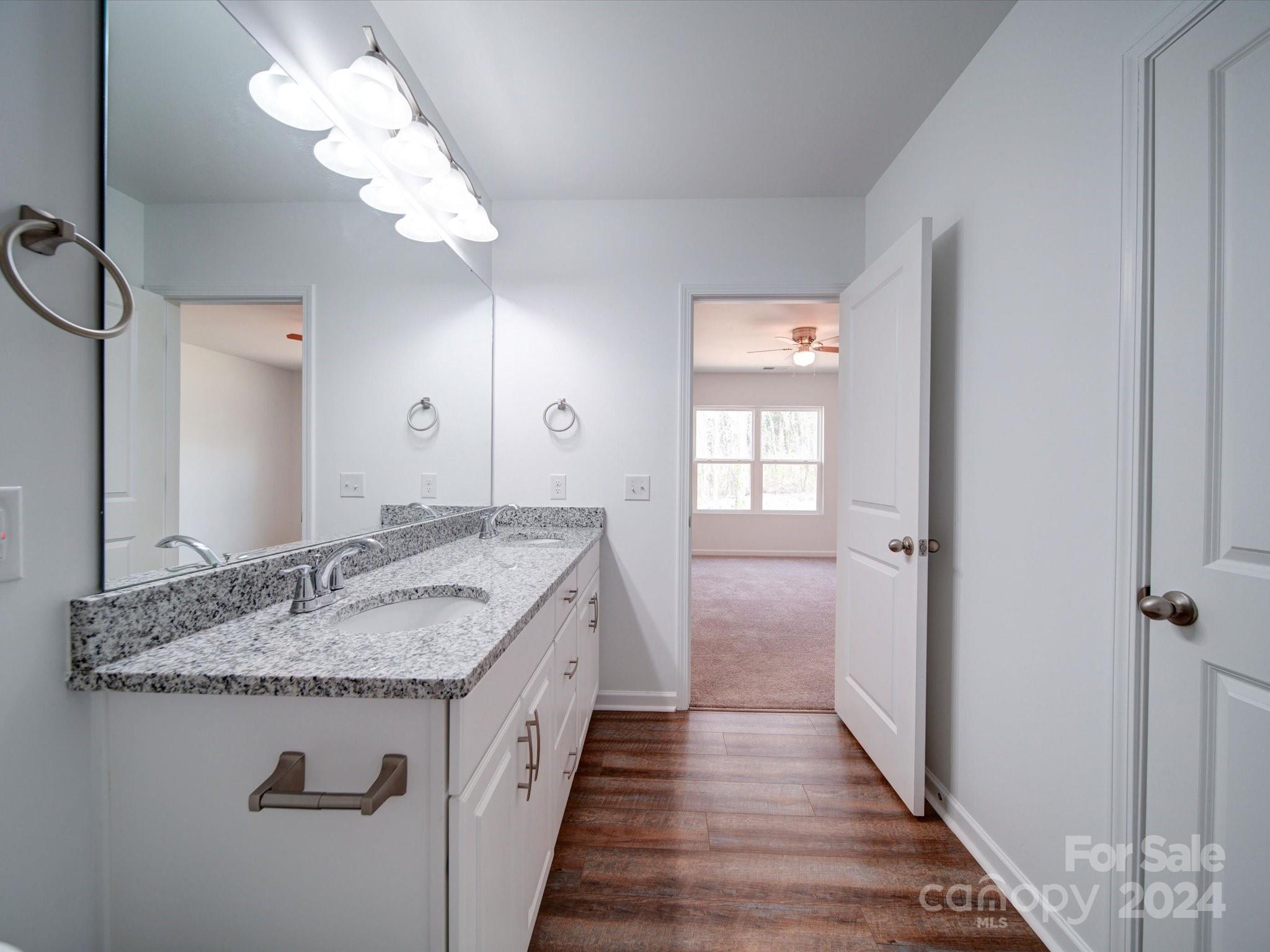 147 Lambeth Road Thomasville, NC 27360 - Photo 19 of 33 a bathroom with a granite countertop sink a mirror and vanity
