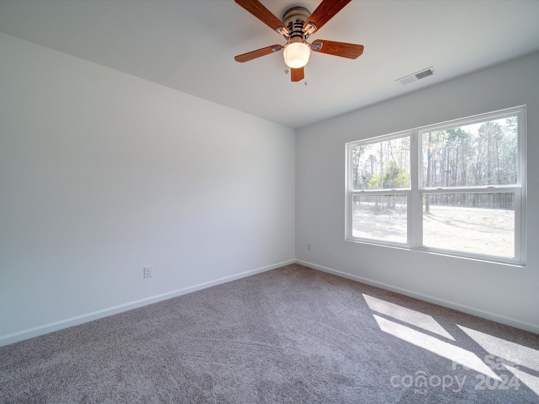 147 Lambeth Road Thomasville, NC 27360 - Photo 21 of 33 an empty room with windows and fan