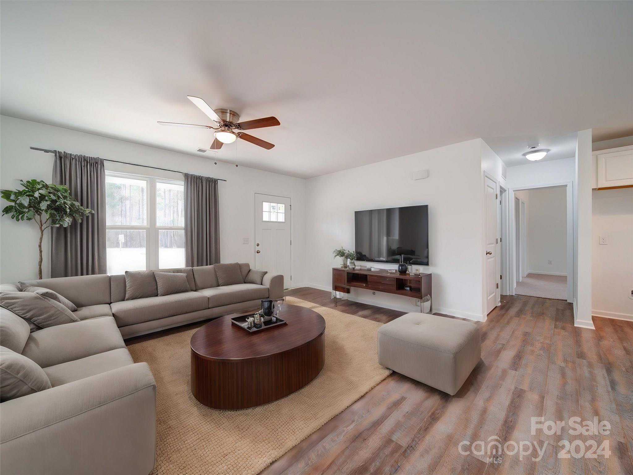 147 Lambeth Road Thomasville, NC 27360 - Photo 3 of 33 a living room with furniture and a flat screen tv