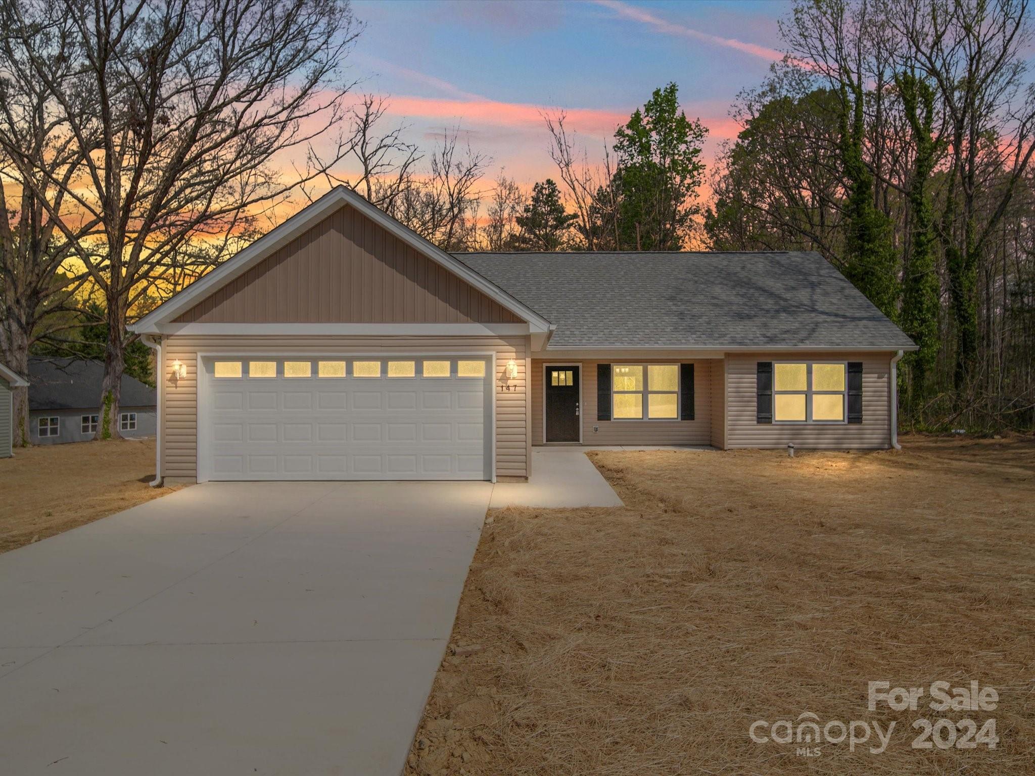 147 Lambeth Road Thomasville, NC 27360 - Photo 33 of 33 a front view of a house with a yard and garage