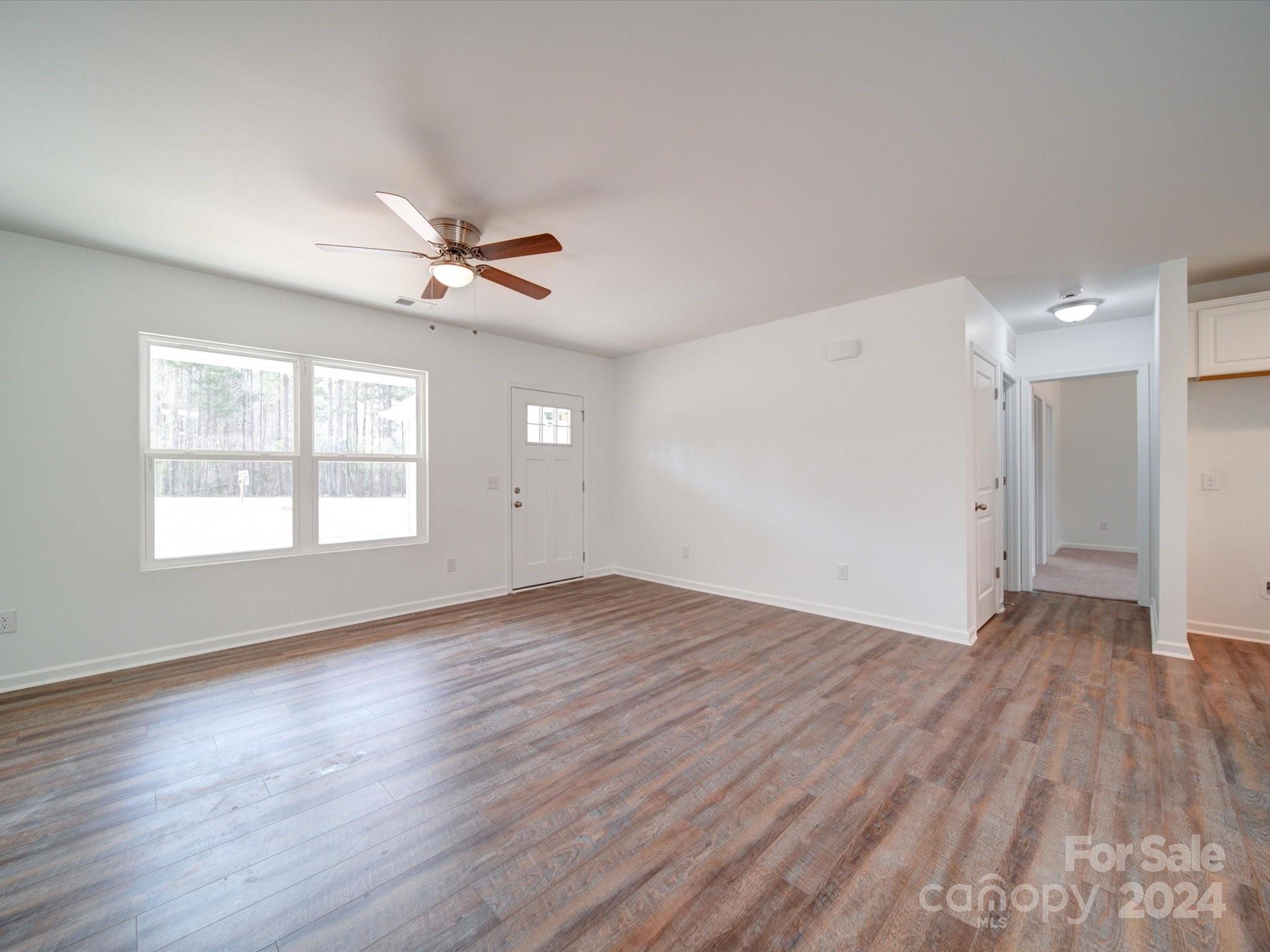 147 Lambeth Road Thomasville, NC 27360 - Photo 4 of 33 an empty room with wooden floor and windows