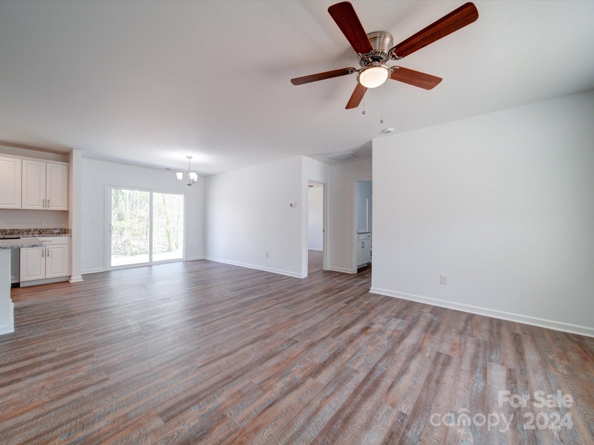 147 Lambeth Road Thomasville, NC 27360 - Photo 5 of 33 a view of an empty room with window and wooden floor