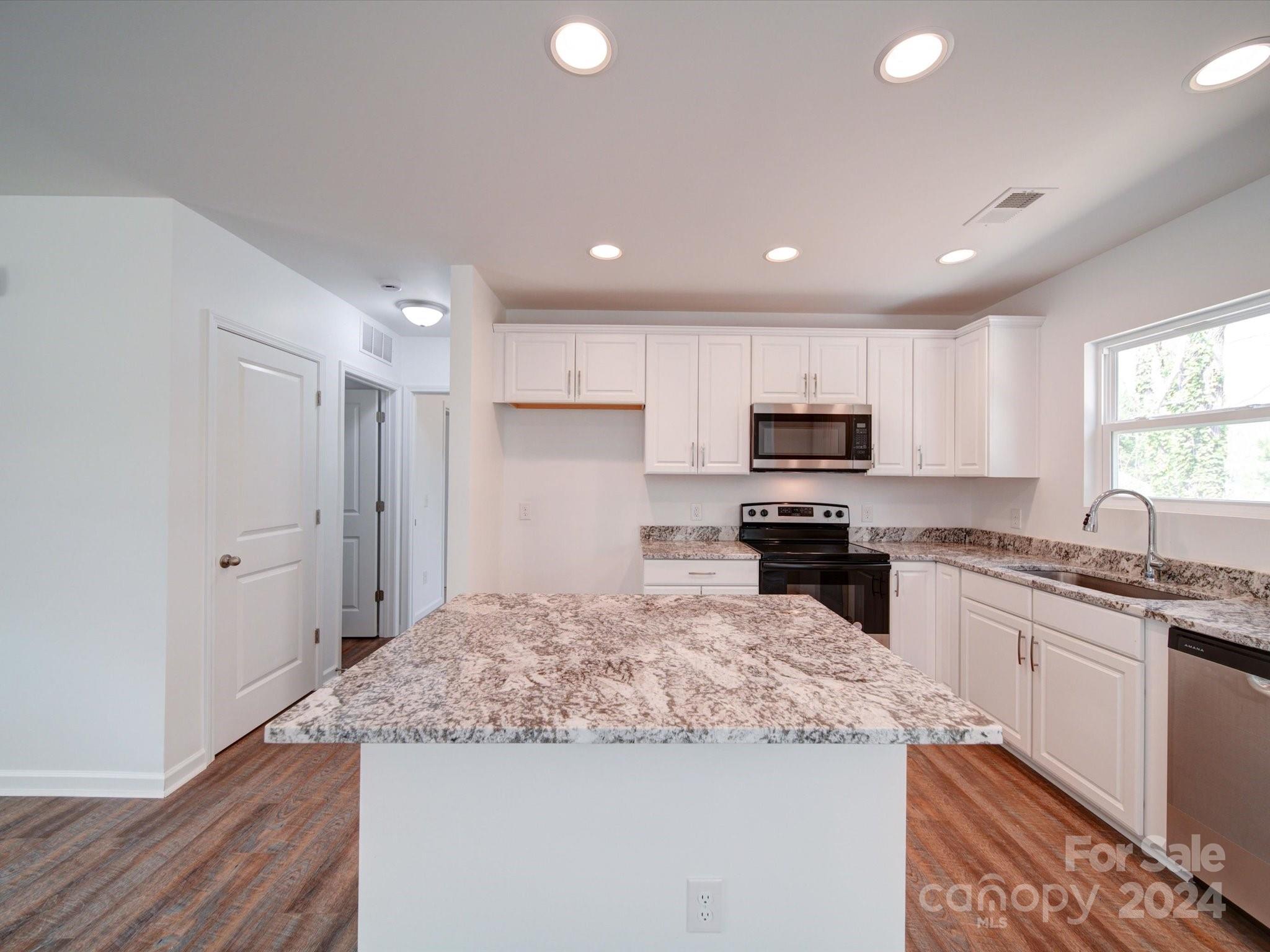 147 Lambeth Road Thomasville, NC 27360 - Photo 9 of 33 a kitchen with granite countertop stainless steel appliances and sink
