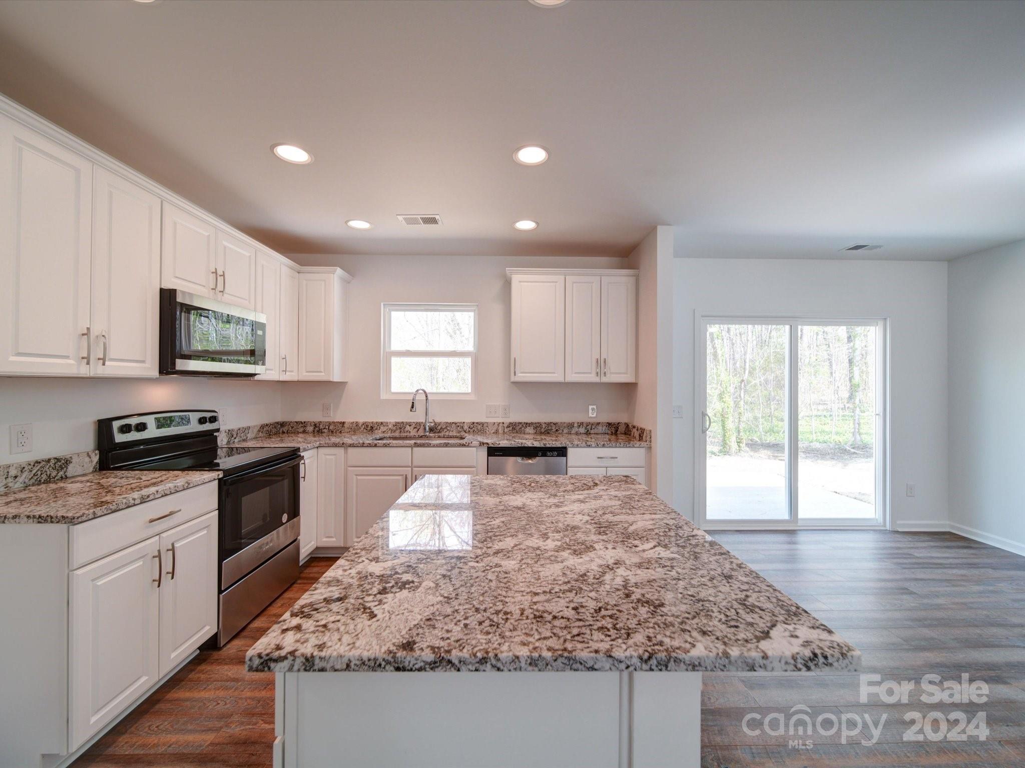 147 Lambeth Road Thomasville, NC 27360 - Photo 10 of 33 a large kitchen with stainless steel appliances granite countertop a stove a sink and a granite counter tops
