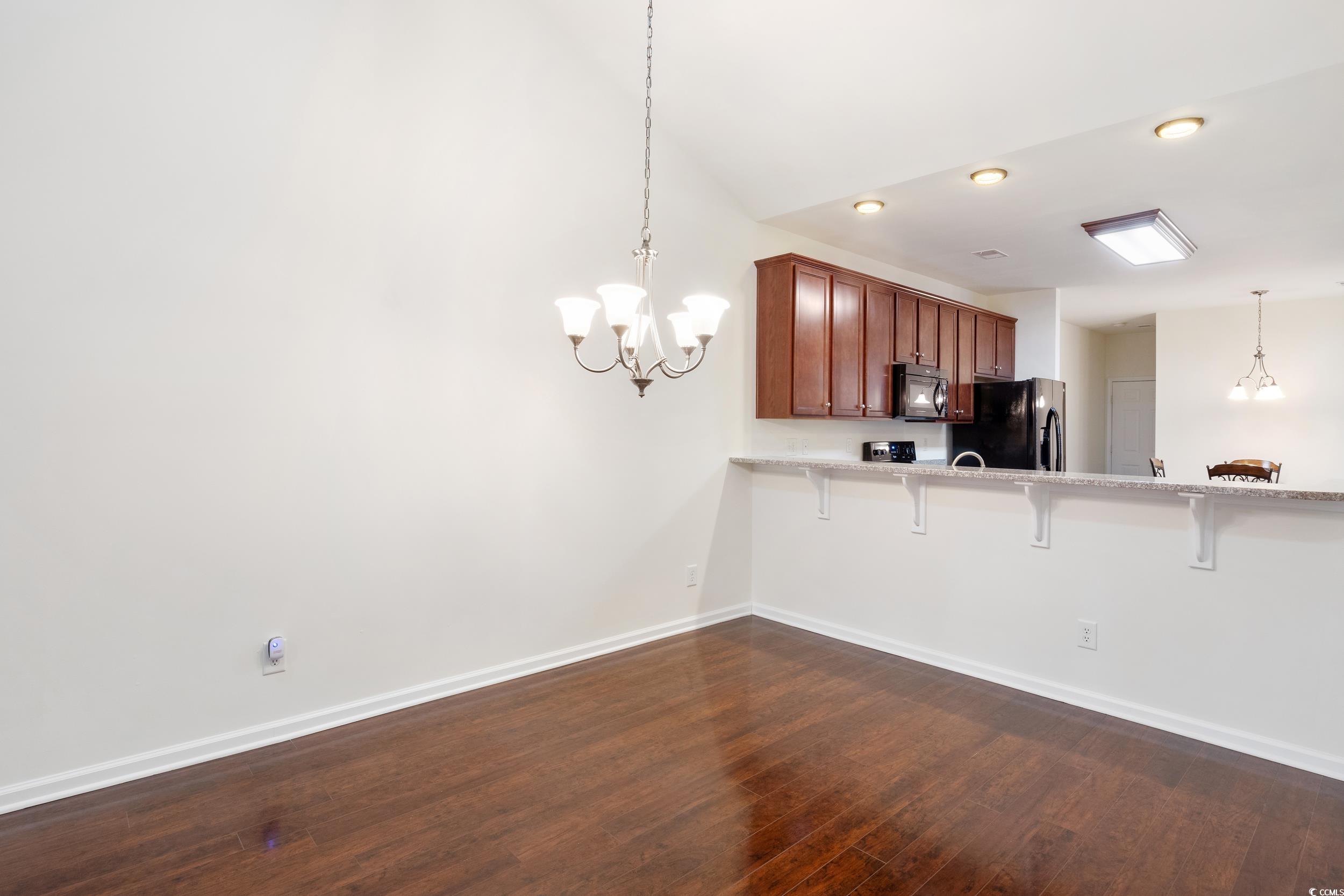1517 Palmina Loop, Unit B Myrtle Beach, SC 29588 - Photo 11 of 30 breakfast bar, dark wood-type flooring