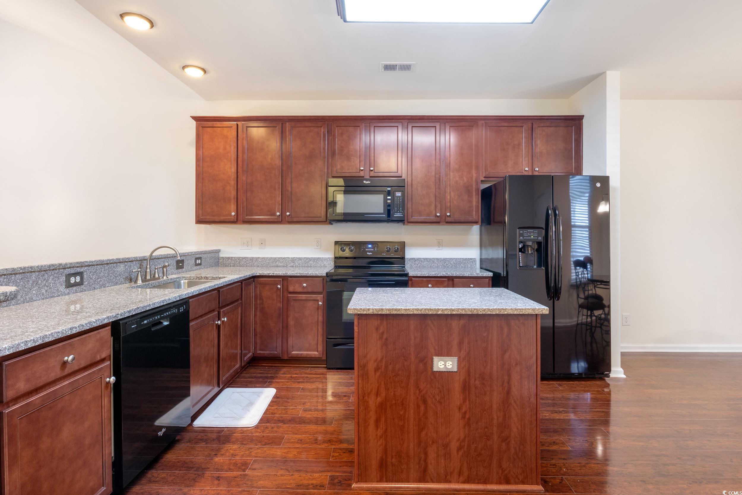 1517 Palmina Loop, Unit B Myrtle Beach, SC 29588 - Photo 12 of 30 Kitchen with light stone counters, a sink, a cente