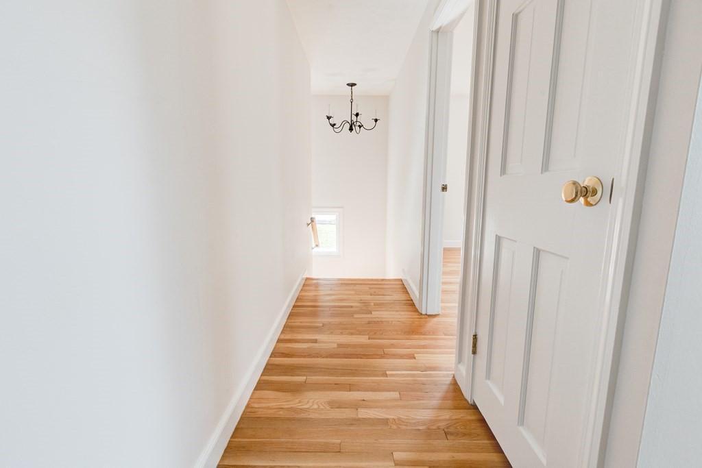 9 Picardy Lane Dover, MA 02030 - Photo 12 of 14 a view of a hallway with wooden floor and closet