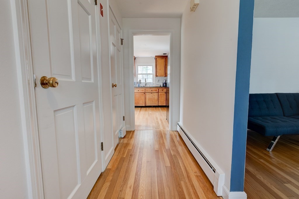 9 Picardy Lane Dover, MA 02030 - Photo 3 of 14 a view of a hallway with wooden floor and staircase