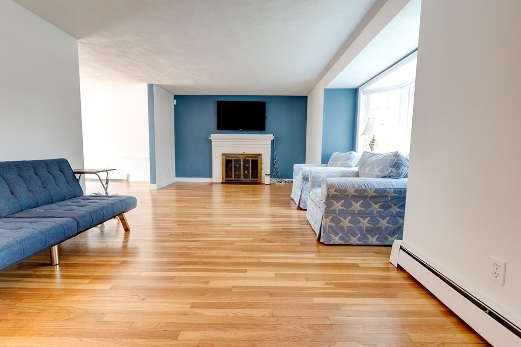 9 Picardy Lane Dover, MA 02030 - Photo 4 of 14 a living room with furniture a fireplace and a flat screen tv