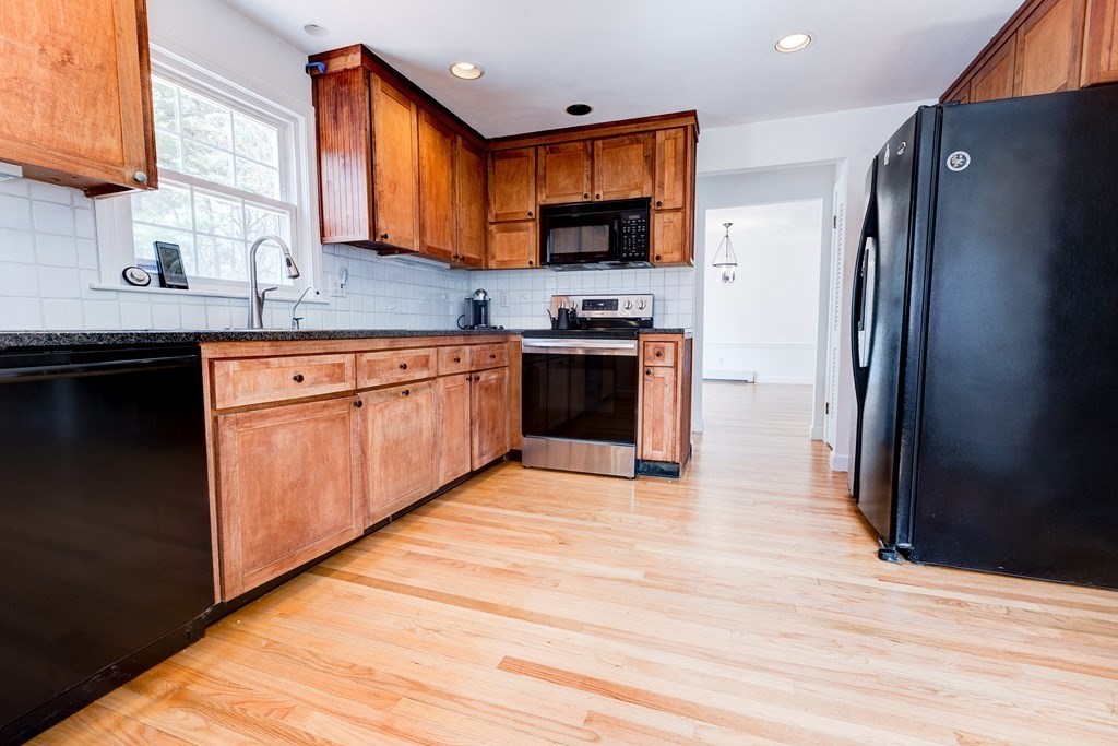 9 Picardy Lane Dover, MA 02030 - Photo 6 of 14 a kitchen with stainless steel appliances granite countertop a refrigerator stove top oven and sink