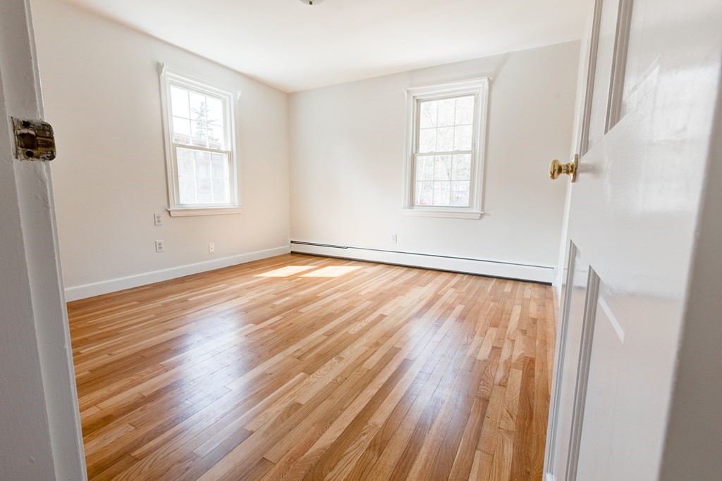9 Picardy Lane Dover, MA 02030 - Photo 10 of 14 an empty room with wooden floor and windows