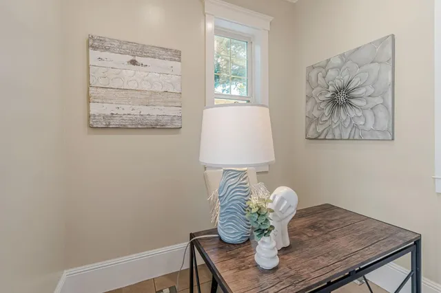 a table with a vase and flowers on it