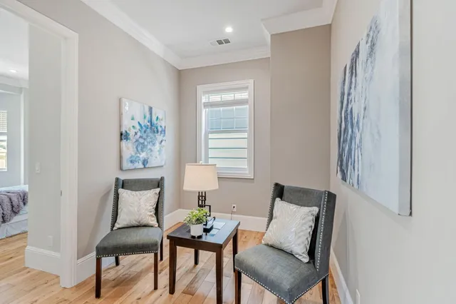 a view of a room with furniture and wooden floor