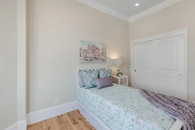 a bedroom with a bed and a painting on the wall