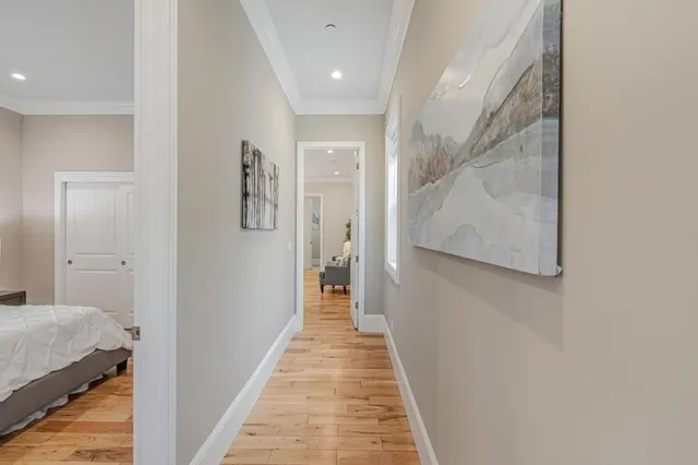 a view of a hallway with wooden floor and staircase