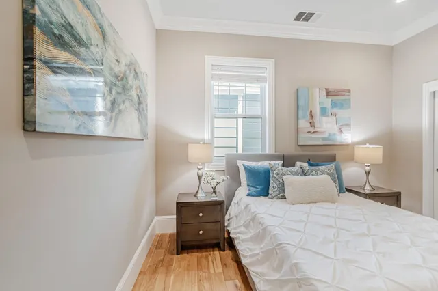a bedroom with a bed and wooden floor