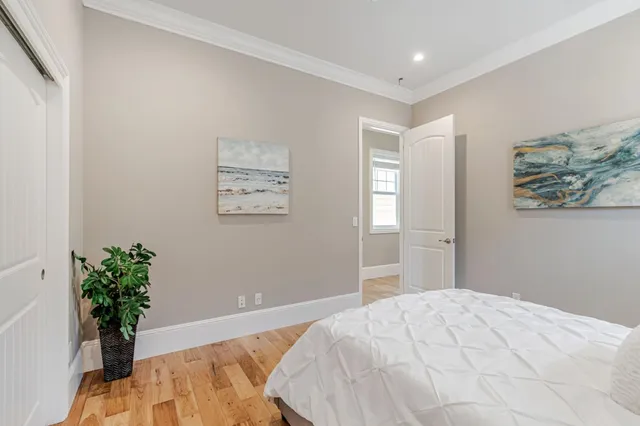 a bedroom with a bed and a potted plant