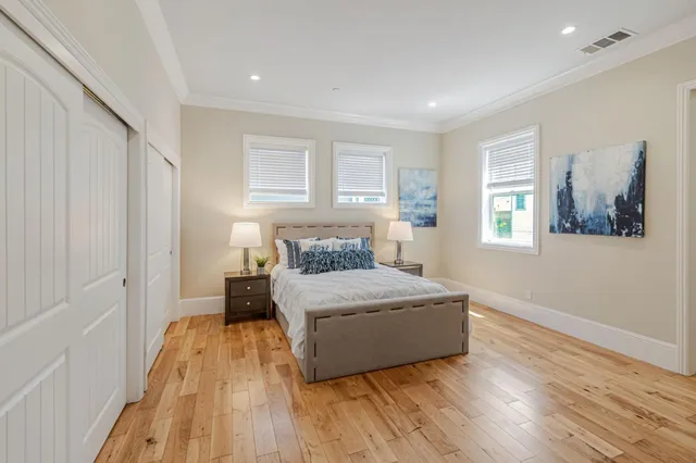 a living room with a bed and a window