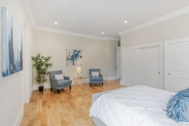 a bedroom with a bed and a potted plant
