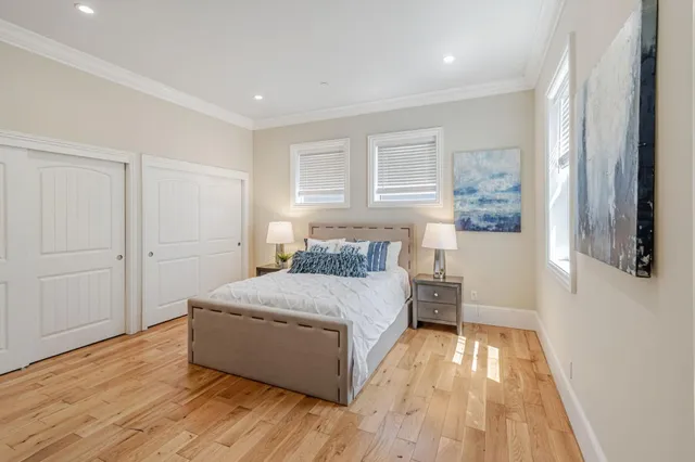 a spacious bedroom with a bed and a window