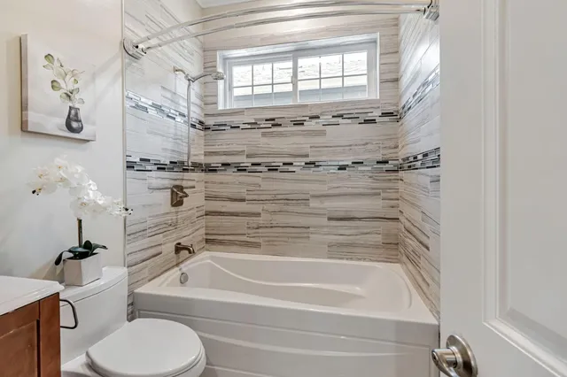 a bathroom with a bathtub and a shower