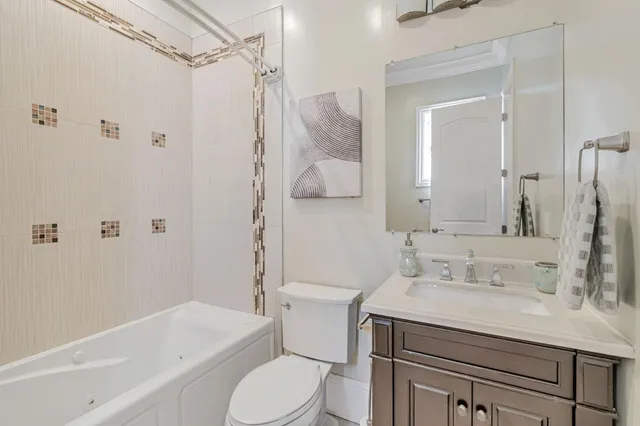a bathroom with a sink toilet vanity and shower