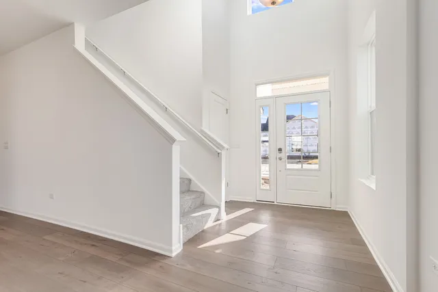 a view of a hallway with wooden floor and entryway