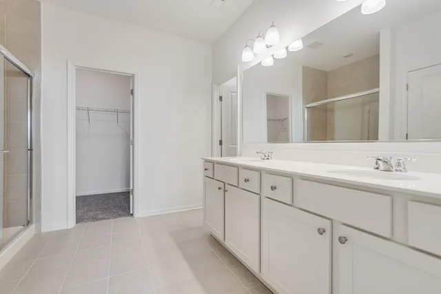 a bathroom with a double vanity sink and a mirror