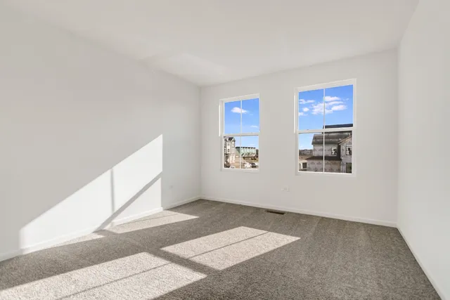 a view of an empty room with windows