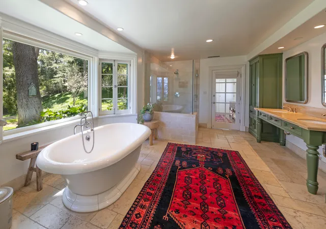 a spacious bedroom with a bed and a bookshelf with wooden floor