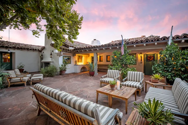 a view of a swimming pool with a yard and large tree